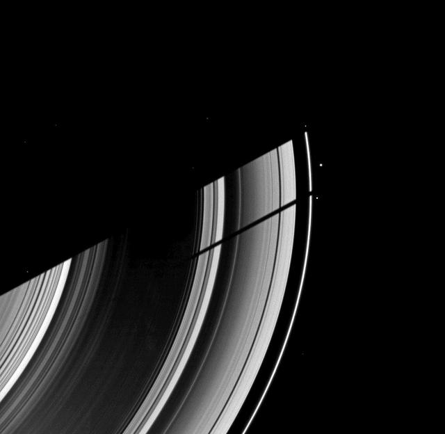 The moon Tethys casts its shadow on Saturn rings next to the shadow of the planet in this image taken as Saturn approaches its August 2009 equinox.