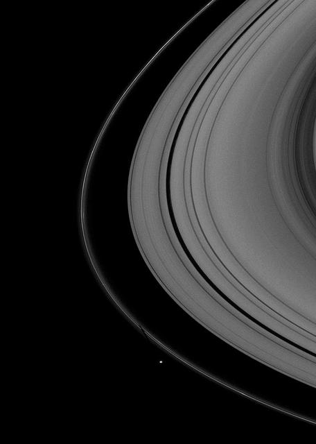 The shepherding moon Pandora, near the bottom of the image, casts a shadow on Saturn thin F ring as the planet nears its August 2009 equinox.