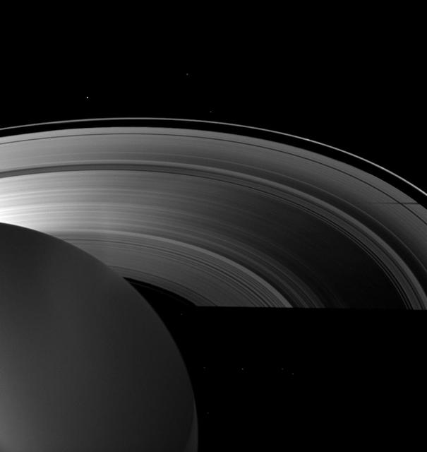 Saturn moon Tethys casts a shadow on the planet A ring alongside the larger shadow cast by the planet itself in this image taken as Saturn approached its August 2009 equinox.