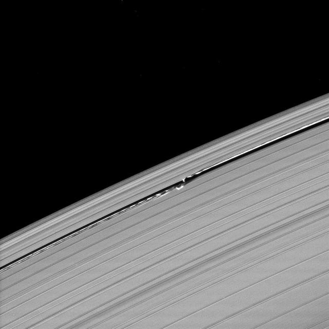 Waves in the edges of the Keeler gap in Saturn A ring, created by the embedded moon Daphnis, show considerable complexity in this image taken as Saturn approached its August 2009 equinox.