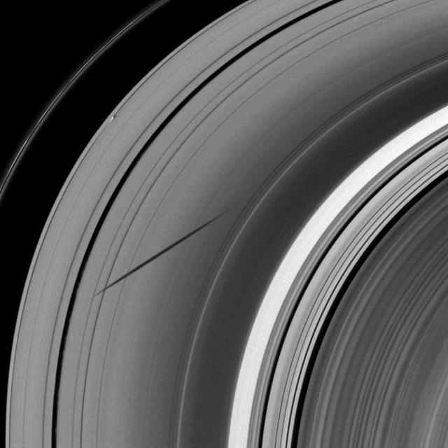 The shadow of the moon Janus dwarfs the shadow of Daphnis on Saturn A ring in this image taken as the planet approached its August 2009 equinox.