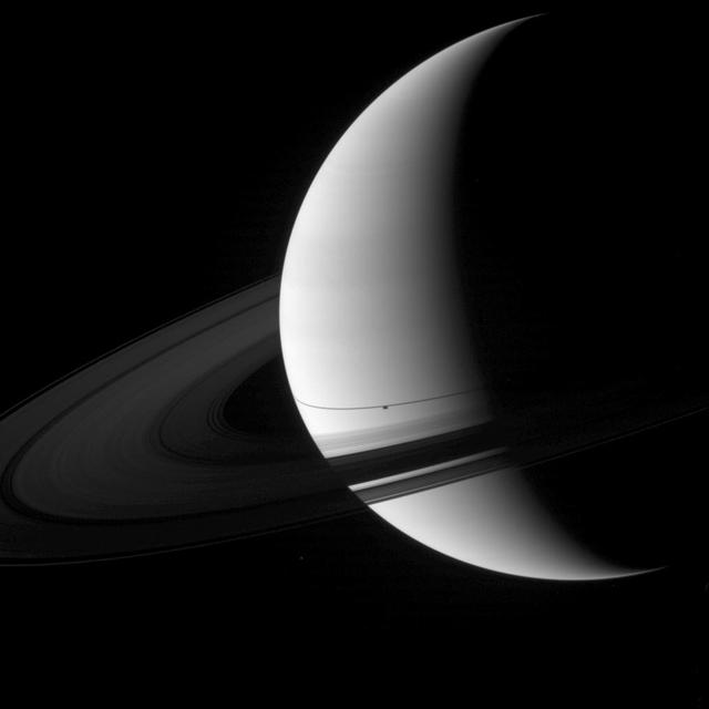 The shadow of the moon Enceladus appears on Saturn just south of the thin shadow of the planet rings in this image captured by NASA Cassini spacecraft.