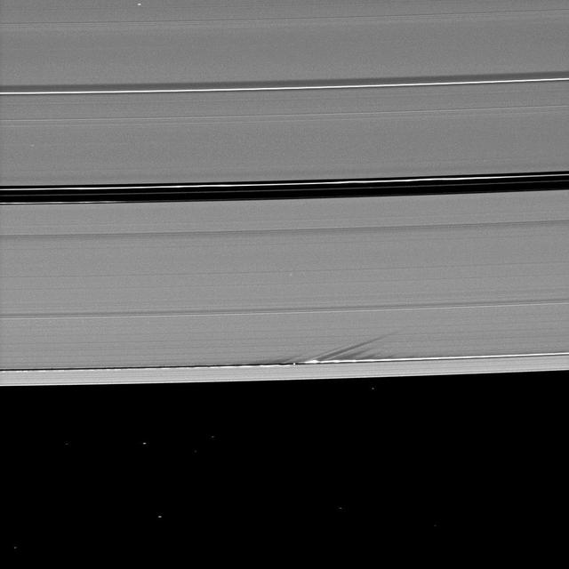 Long shadows stretch away from the towering edge waves created by the gravity of the moon Daphnis in this image taken by NASA Cassini spacecraft a little more than a week before Saturn August 2009 equinox.