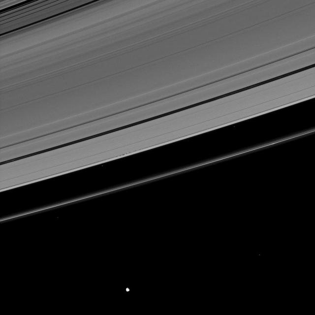 This image, which at first appears to show a serene scene, in fact   reveals dramatic disturbances created in Saturn A ring by its moon   Daphnis as seen by NASA Cassini spacecraft.