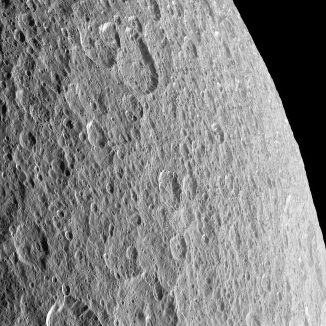 Craters imprinted upon other craters record the long history of impacts endured by Saturn moon Rhea; this image was taken by NASA Cassini spacecraft.
