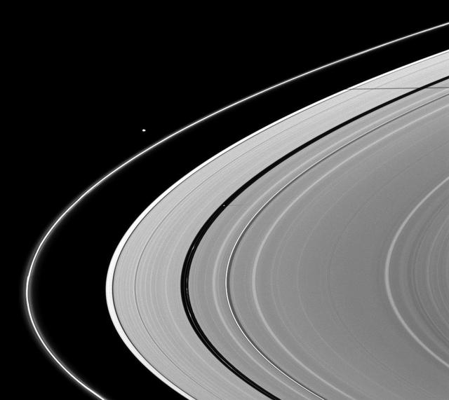 A pair of Saturn moons, Pan and Janus, cast their shadows on the A ring in this NASA Cassini spacecraft image taken about a month and a half after Saturn August 2009 equinox.