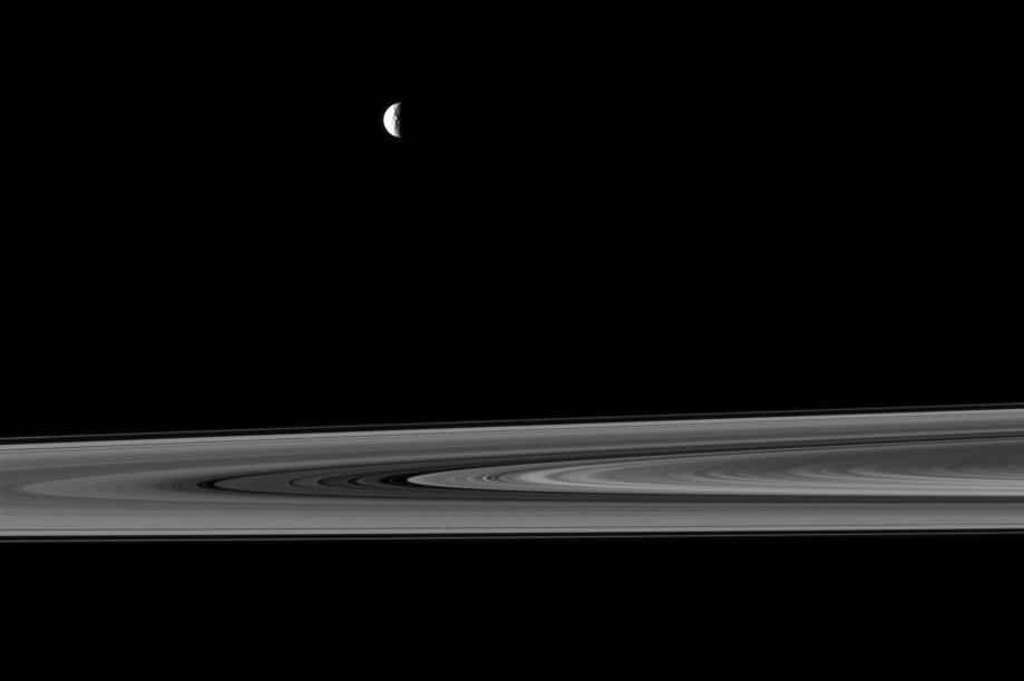 NASA Cassini spacecraft captures a couple of small moons in this image taken while the spacecraft was nearly in the plane of Saturn rings.