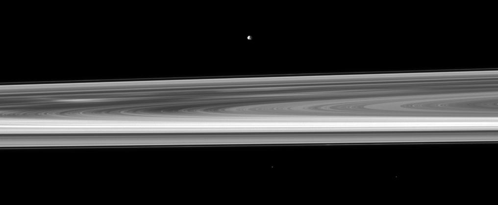 Orbiting near the plane of Saturn rings, NASA Cassini spacecraft looks across the span of the rings to spy the small moon Epimetheus. The brightest spoke is visible on the left of the image.