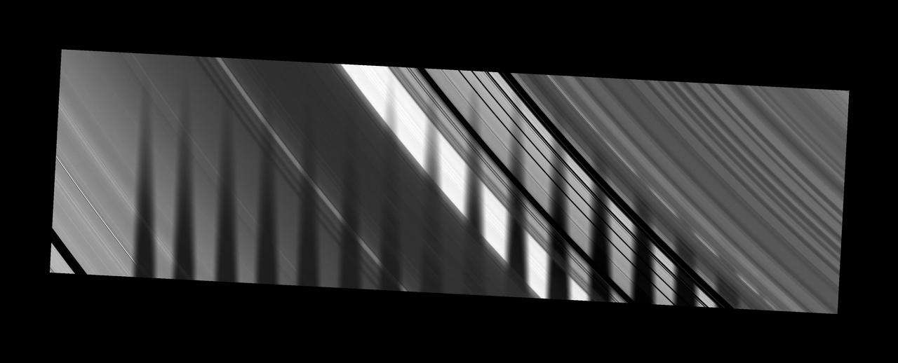 NASA Cassini spacecraft captures the shadow of Saturn moon Tethys as it seems to disappear as it crosses the planet rings.