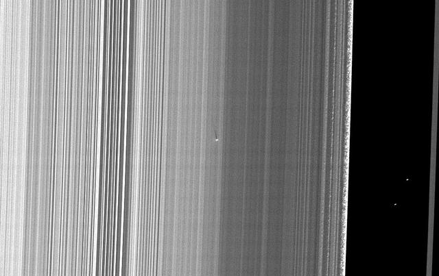 The Cassini spacecraft captured this image of a small object in the outer portion of Saturn B ring casting a shadow on the rings as Saturn approaches its August 2009 equinox.