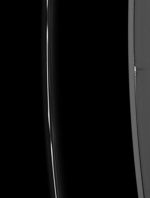 Ring material, pulled to spectacular heights above the ring plane by the gravity of the moon Daphnis, casts long shadows on Saturn’s A ring in this Cassini image taken about a month before the planet’s August 2009 equinox.