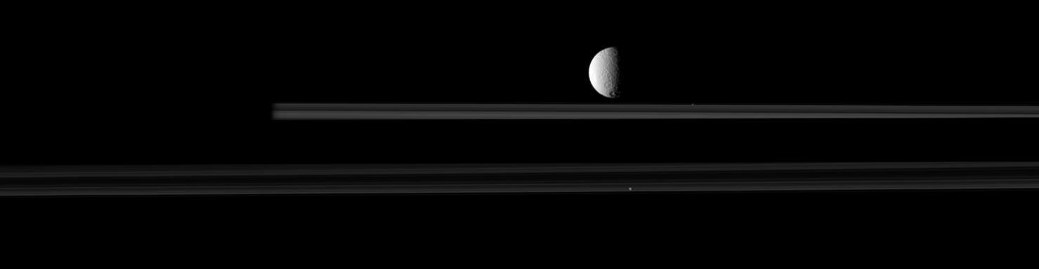 The moon Tethys is upstaged by two smaller moons, Pandora and Prometheus, in this image from NASA Cassini spacecraft. Go to the Photojournal to view the animation.