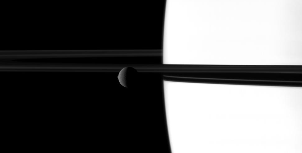 The small moon Janus overtakes the larger moon Rhea in a dance played out before Saturn and its rings in this image taken by NASA Cassini spacecraft. Go to the Photojournal to view the animation.