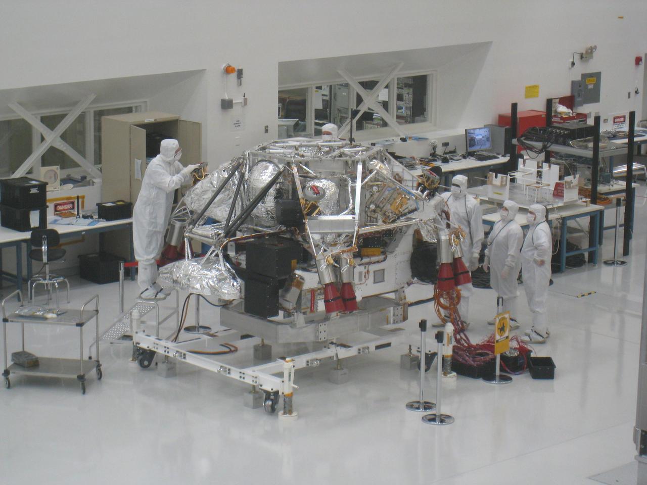 In this February 17, 2009, image, NASA Mars Science Laboratory rover is attached to the spacecraft descent stage. The image was taken inside the Spacecraft Assembly Facility at NASA JPL, Pasadena, Calif.