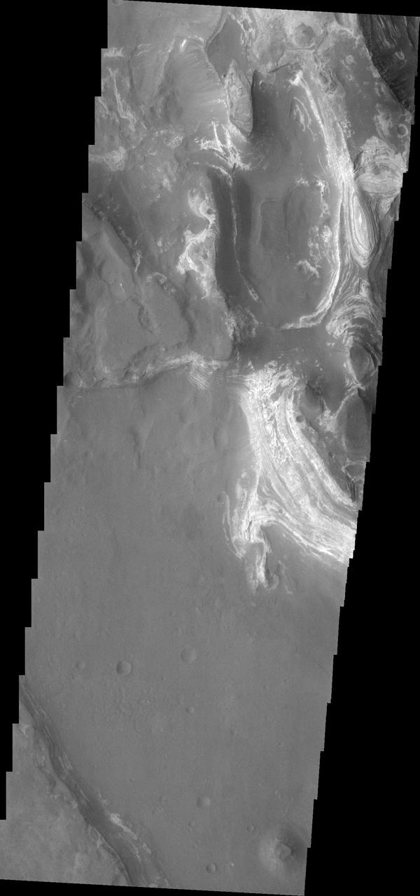 This image shows some of the eroded, layered crater fill material within Terby Crater.