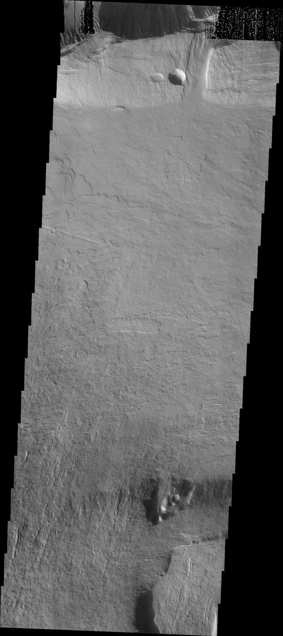 This image, taken by NASA Mars Odyssey spacecraft, shows flow features on the northern flank of Olympus Mons.