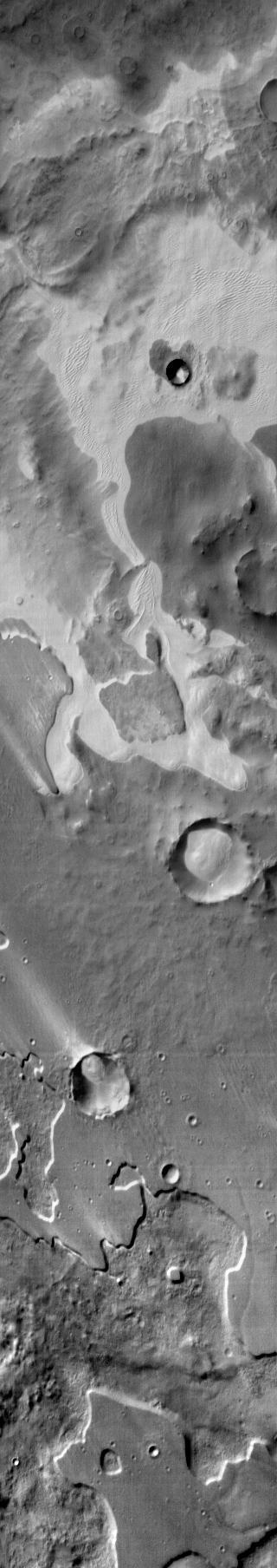 An extensive sand sheet and dunes are located within Pityusa Patera. This daytime infrared image shows that the sand is relatively warmer than the surrounding materials.