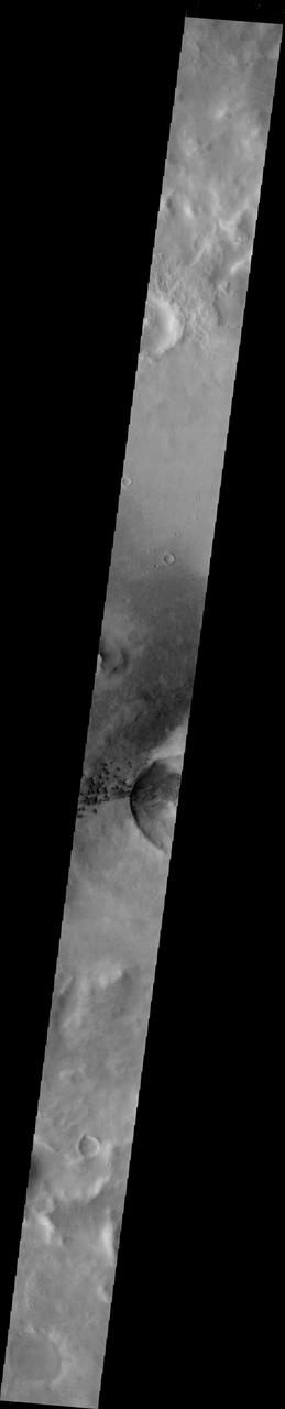 This image from NASA 2001 Mars Odyssey crosses Green Crater.The small dark dunes are located on the floor of Green Crater near a younger impact.