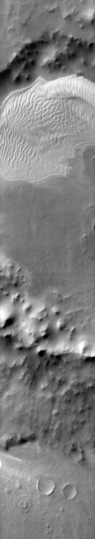 This daytime infrared image shows the large sand sheet on the floor of Charlier Crater. The brightness is due to the warmth of the sand during the day.
