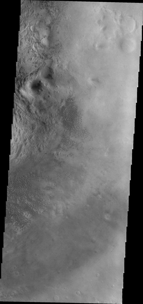 Small, dark sand dunes are located on the floor of Moreux Crater.