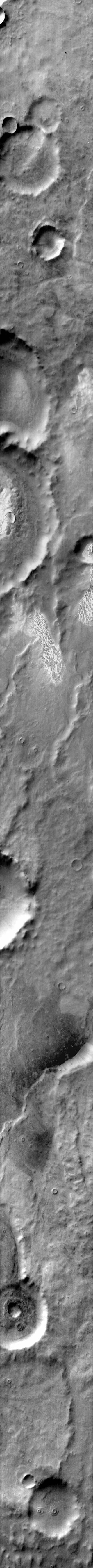 This daytime 2001 Mars Odyssey image of Terra Cimmeria shows dunes occurring both on crater floors and on the plains between the craters.