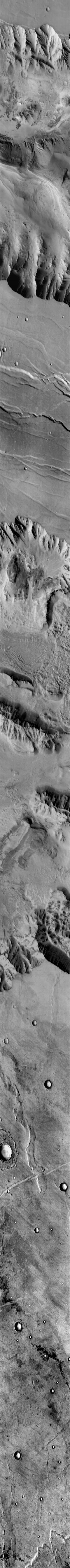 This Mars Odyssey image transects Candor Chasma and Melas Chasma. Many canyon features are clearly visible in the image, including the steep cliff faces, landslides, and layered canyon floor deposits.