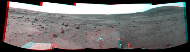 NASA Mars Exploration Rover Spirit took the images combined to make this stereo view on March 21, 2009. West is at the center, where a dust devil is visible in the distance. 3D glasses are necessary to view this image.