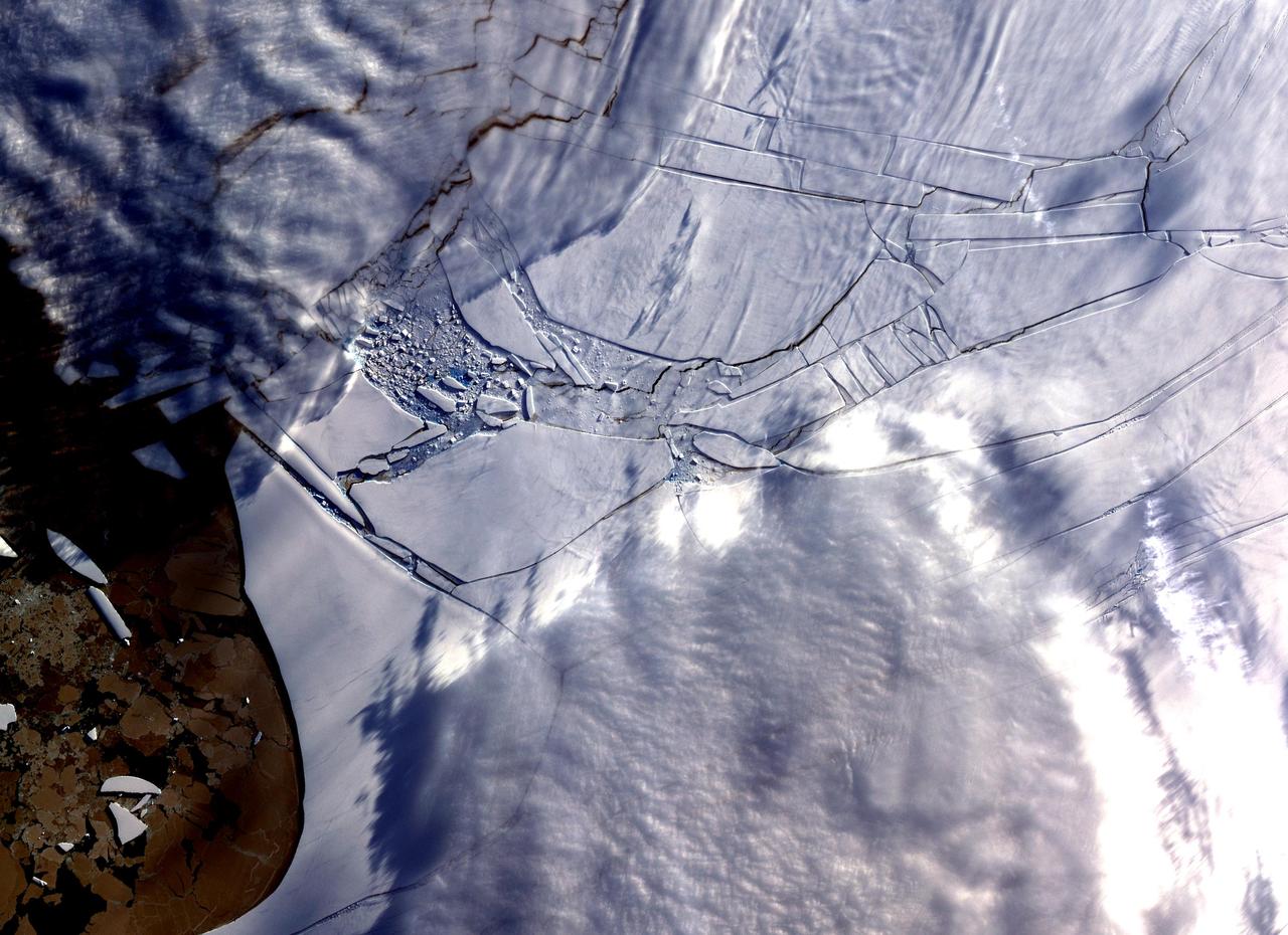 The Wilkins Ice Shelf, as seen by NASA Terra spacecraft, on the western side of the Antarctic Peninsula, experienced multiple disintegration events in 2008. By the beginning of 2009, a narrow ice bridge was all that remained to connect the ice shelf to ice fragments fringing nearby Charcot Island. That bridge gave way in early April 2009. Days after the ice bridge rupture, on April 12, 2009, the Advanced Spaceborne Thermal Emission and Reflection Radiometer (ASTER) on NASA's Terra satellite acquired this image of the southern base of the ice bridge, where it connected with the remnant ice shelf. Although the ice bridge has played a role in stabilizing the ice fragments in the region, its rupture doesn't guarantee the ice will immediately move away.  http://photojournal.jpl.nasa.gov/catalog/PIA11991