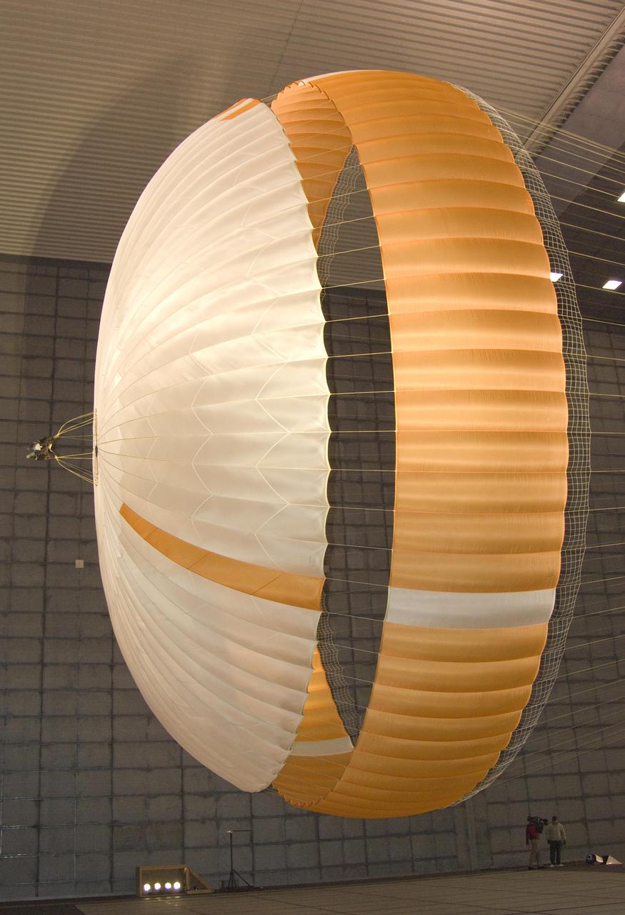 The parachute for NASA Mars Science Laboratory mission opens to a diameter of nearly 16 meters 51 feet. This image shows a duplicate qualification-test parachute inside the world's largest wind tunnel, at NASA Ames Research Center, Moffett Field, Calif. The Mars Science Laboratory will be launched in 2011 for a landing on Mars in 2012. Its parachute is the largest ever built to fly on an extraterrestrial mission. The parachute uses a configuration called disk-gap-band, with 80 suspension lines. Most of the orange and white fabric is nylon, though a small disk of heavier polyester is used near the vent in the apex of the canopy due to higher stresses there. http://photojournal.jpl.nasa.gov/catalog/PIA11994