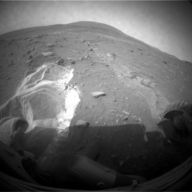 Wheel slippage during attempts to extricate NASA's Mars Rover Spirit from a patch of soft ground during the preceding two weeks had partially buried the wheels by the 1,899th Martian day, or sol, of the Spirit's mission on Mars (May 6, 2009).  Spirit took this image with its front hazard-avoidance camera on Sol 1899. With Spirit in the position shown here, the rover team temporarily suspended driving attempts while studying the ground around Spirit and planning simulation tests of driving options with a test rover at NASA's Jet Propulsion Laboratory in Pasadena, Calif.  Driving attempts between the time Spirit took a similar image (PIA12002) 10 sols earlier and when this image was taken moved the rover a total of about 36 centimeters (14 inches).  While driving backwards, the rover drags its right front wheel, which no longer rotates. For scale, the distance between the wheel tracks is about 1 meter (40 inches). This view is looking northward, with Husband Hill on the horizon.  http://photojournal.jpl.nasa.gov/catalog/PIA12007
