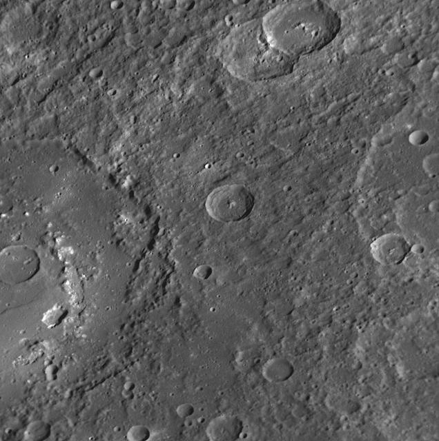 The large crater extending out the left side of this image is Praxiteles.  Named for the ancient Greek sculptor of the 4th century BC, Praxiteles  crater was first observed by Mariner 10.