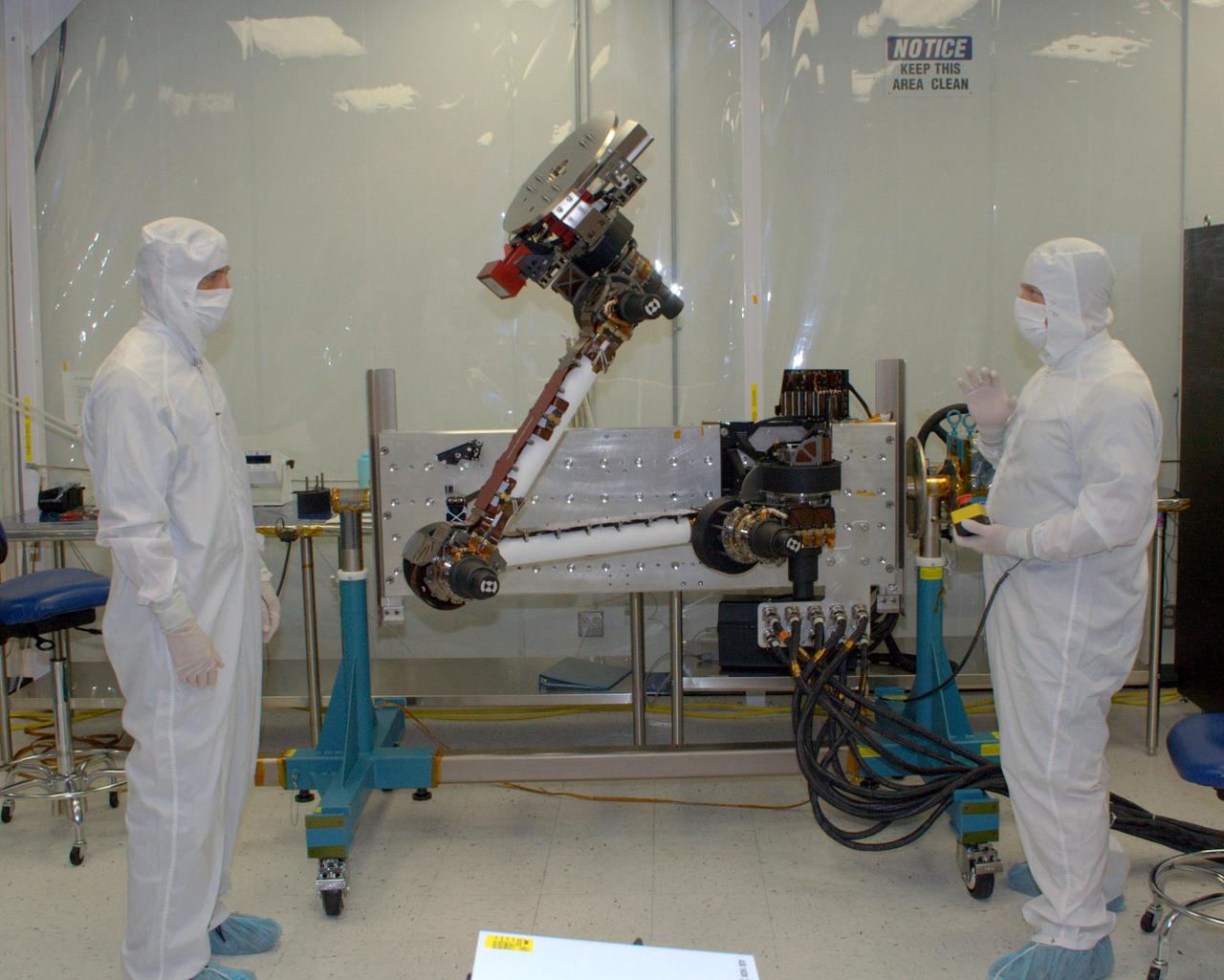 Engineers from NASA Jet Propulsion Laboratory and Alliance Spacesystems are testing the range of motion of the Mars Science Laboratory rover’s robotic arm joints.