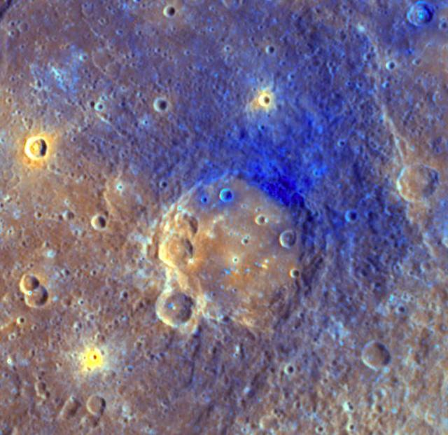 On Mercury, NASA MESSENGER shows the smooth floor of Titian is a brighter orange color than the surrounding area, likely due to being filled with volcanic material. Ejecta from Titian appears blue.