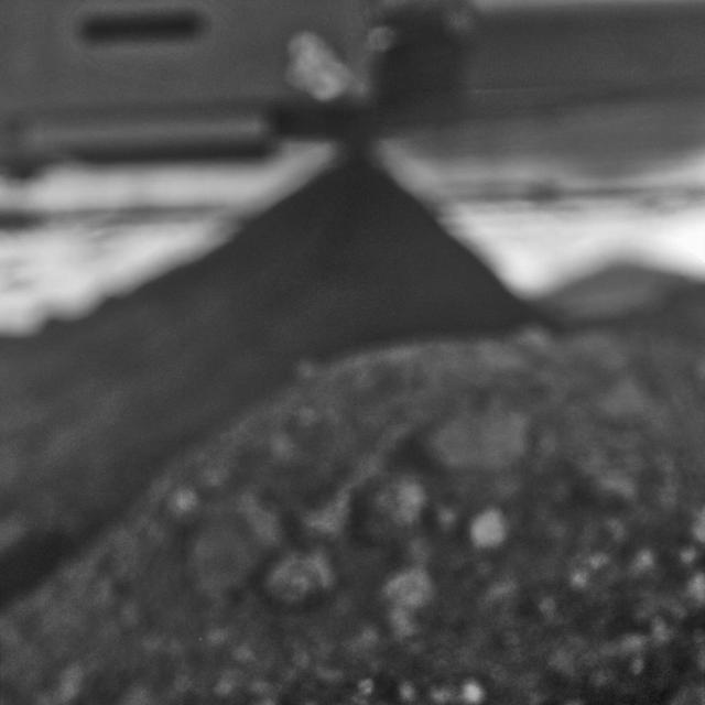 This mosaic image was taken with the microscopic imager on NASA Mars Exploration Rover Spirit to get a look underneath the rover.