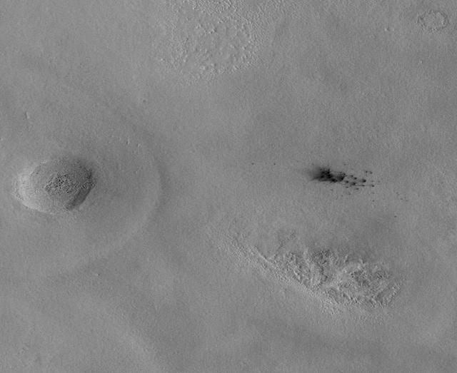 The Context Camera aboard NASA Mars Reconnaissance Orbiter discovers new dark spots on Mars that, upon closer examination, turn out to be brand new impact craters.