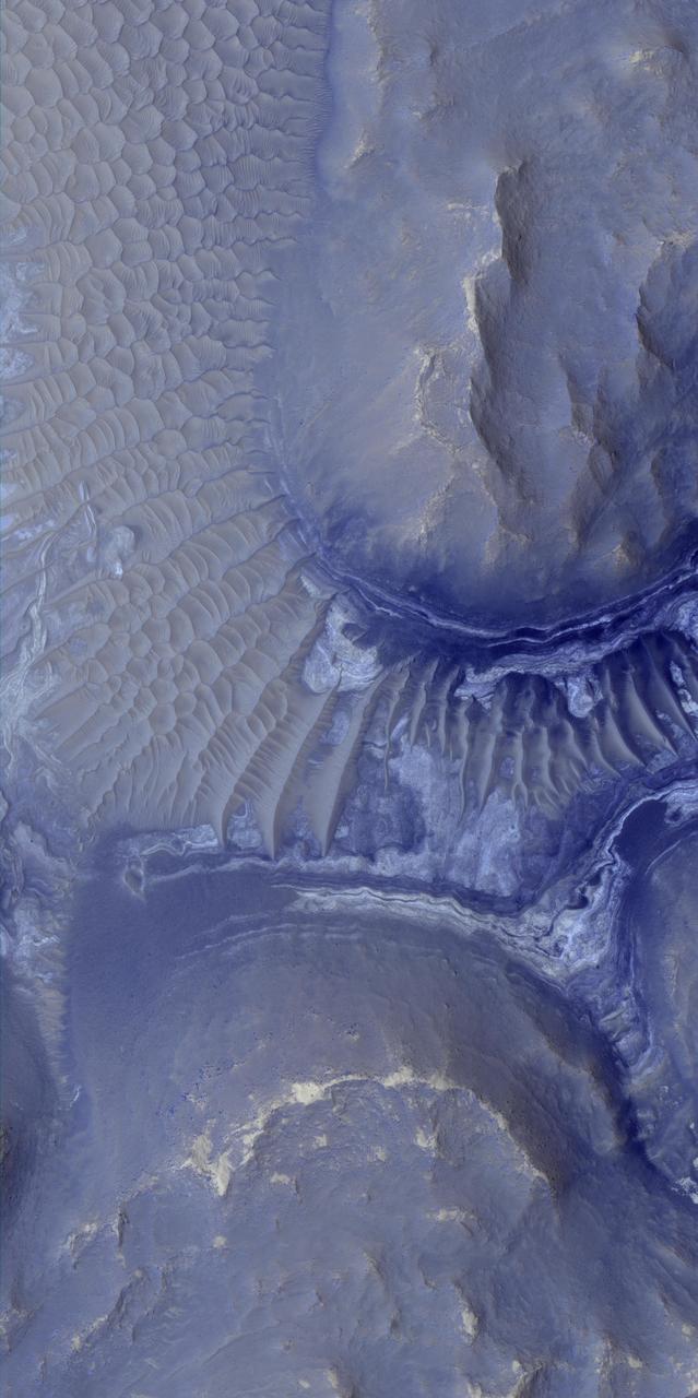 Layers in the lower portion of two neighboring buttes within the Noctis Labyrinthus formation on Mars are visible in this image from NASA Mars Reconnaissance Orbiter.