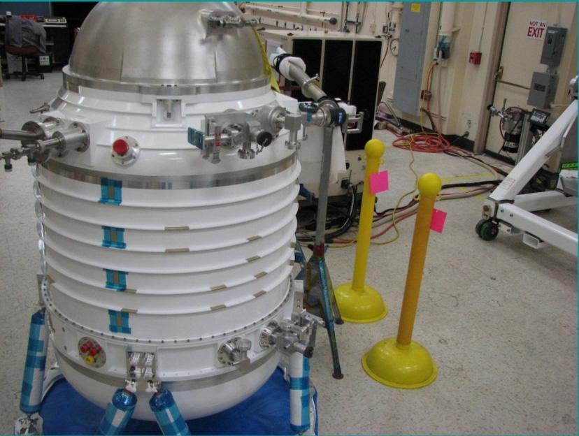 Initial assembly of NASA Wide-field Infrared Survey Explorer cryostat. The cryostat is a 2-stage solid hydrogen dewar that is used to cool the WISE optics and detectors. Here the cryostat internal structures are undergoing their initial vacuum pumpdown.