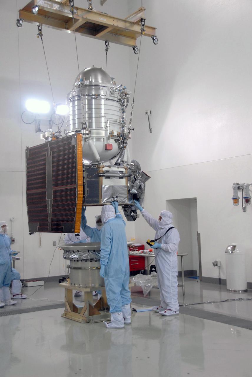 At Vandenberg Air Force Base Astrotech processing facility in California, NASA Wide-field Infrared Survey Explorer, or WISE, spacecraft is lowered toward the flight conical adapter and test stand.