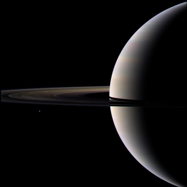 Looking cool and serene, Saturn shares its soft glow with NASA Cassini Orbiter.