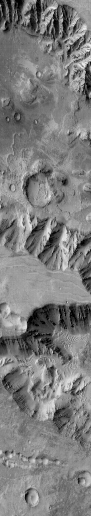 NASA 2001 Mars Odyssey shows part of the floor of Coprates Chasma which contains various deposits, including dune fields.