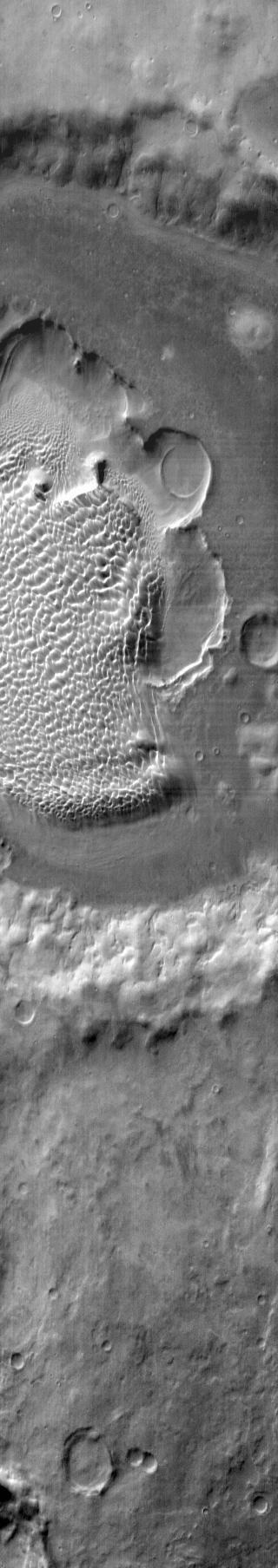 This image from NASA 2001 Mars Odyssey shows the sand sheet with dune forms located on the floor of Rabe Crater.