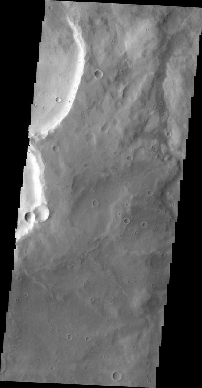 The dark slope streaks in this image are located on the rim of an unnamed crater east of Schiaparelli Crater taken by NASA 2001 Mars Odyssey spacecraft.