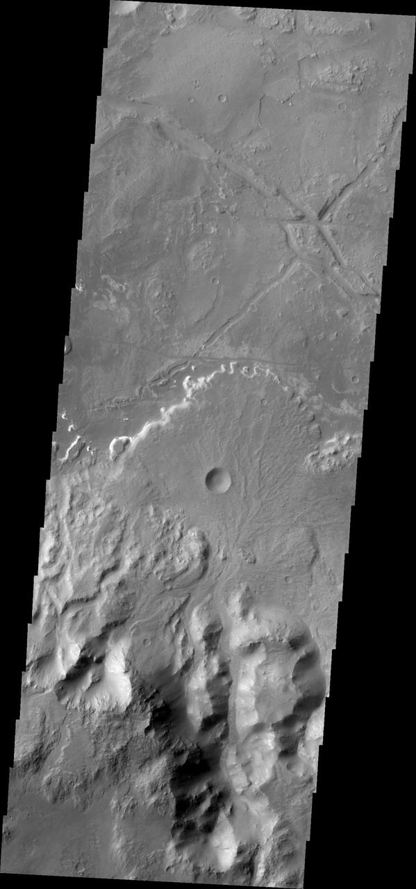 Taken by NASA 2001 Mars Odyssey spacecraft, this image shows a fan shaped deposit located on the floor of Holden Crater.