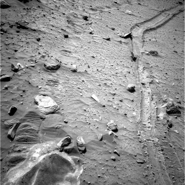 This view from the navigation camera near the top of the mast on NASA Mars Exploration Rover Spirit shows the tracks left by the rover as it drove southward and backward, dragging its inoperable right-front wheel.