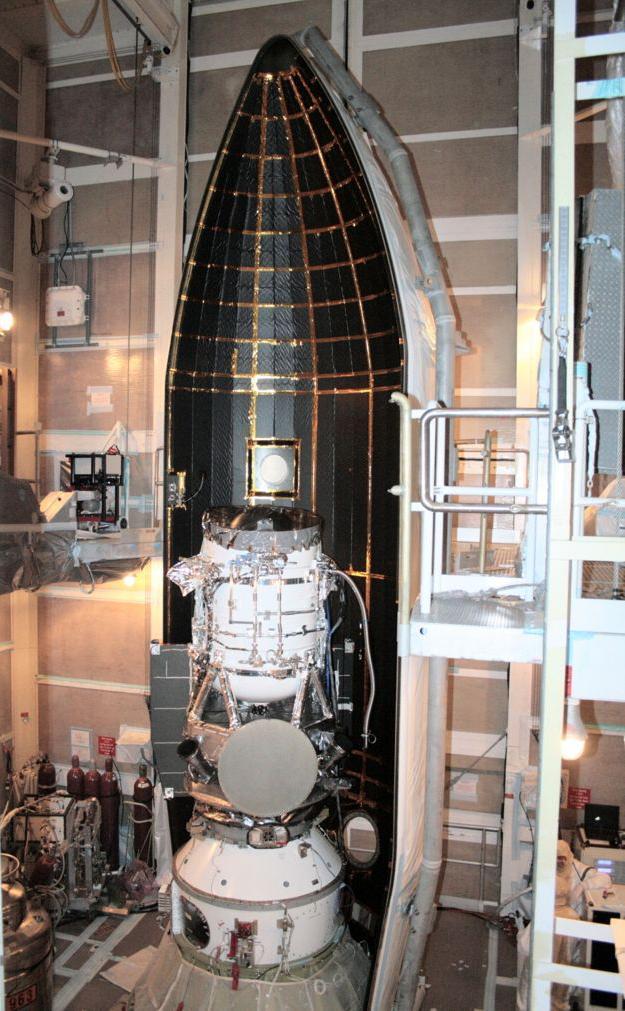 NASA Wide-field Infrared Survey Explorer is shown inside one-half of the nose cone, or fairing, that will protect it during launch.