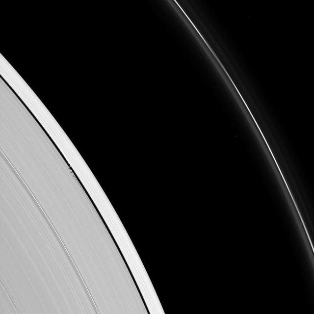 Tiny Daphnis appears as a bright dot in the Keeler Gap next to shadows cast by the moon and the edge waves it has created in the A ring in this image taken by NASA Cassini spacecraft before Saturn August 2009 equinox.