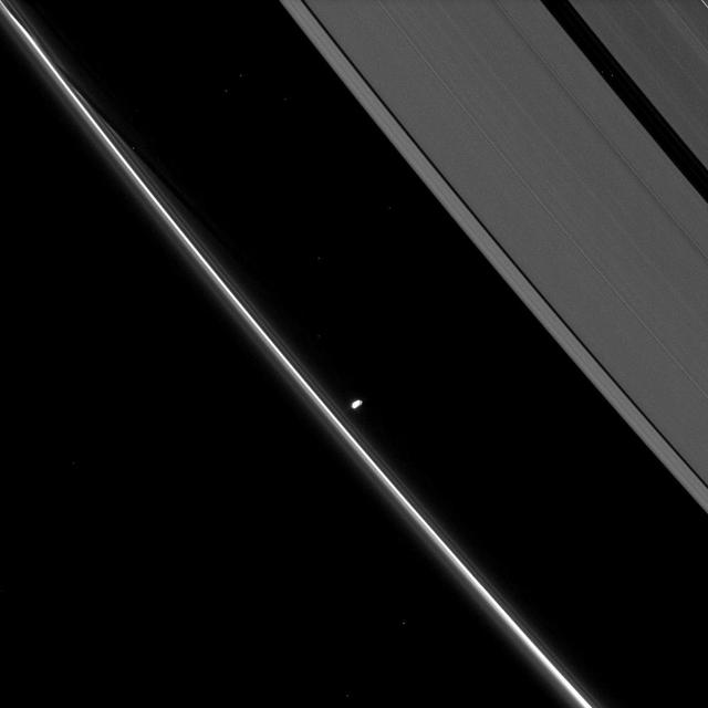 Saturn small moon Prometheus, slightly overexposed in this image taken by NASA Cassini spacecraft, shows off its potato-like shape as it orbits in the Roche Division between the A ring and thin F ring.
