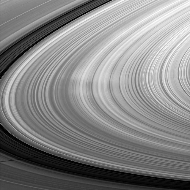 Bright spokes grace the B ring in this image which also includes the shadow of the moon Mimas and was taken by NASA Cassini spacecraft about a month after Saturn August 2009 equinox.