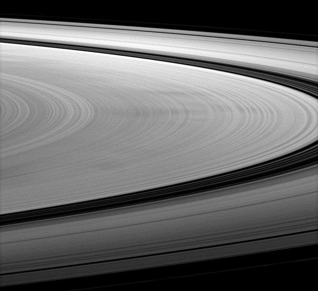NASA Cassini spacecraft images dark spokes on Saturn B ring. Spokes are radial markings on Saturn rings that continue to interest scientists, and they can be seen here stretching left to right across the image.