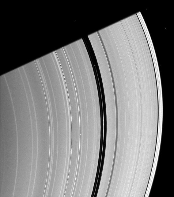 Saturn moon Pan, orbiting in the Encke Gap near the top of the image, casts a short shadow on the A ring in this image taken by NASA Cassini spacecraft about six months after the planet August 2009 equinox.